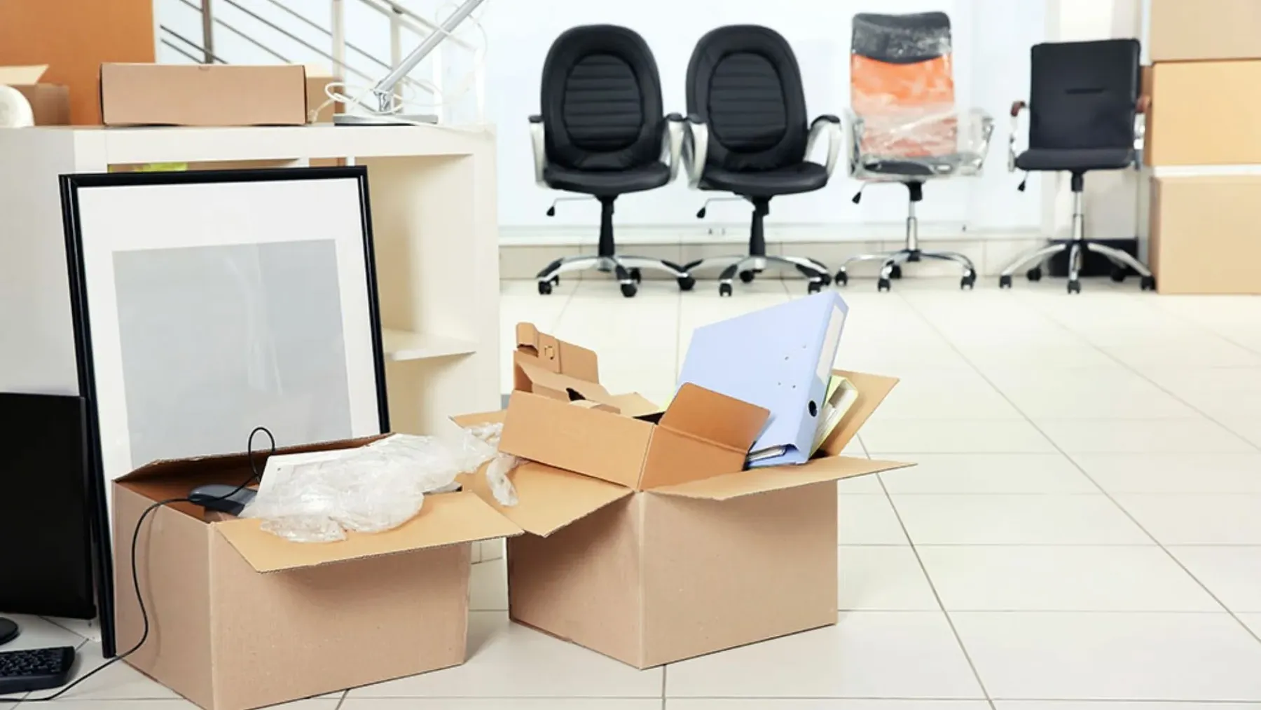 Office chairs and packed boxes ready for an office move